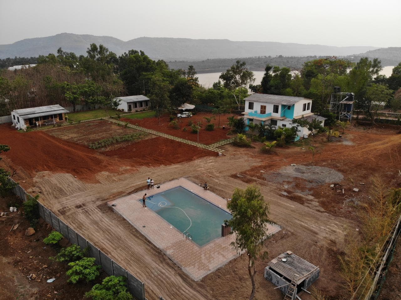 Aerial view of LakesideMantra Resort and the green landscape around Kamshet